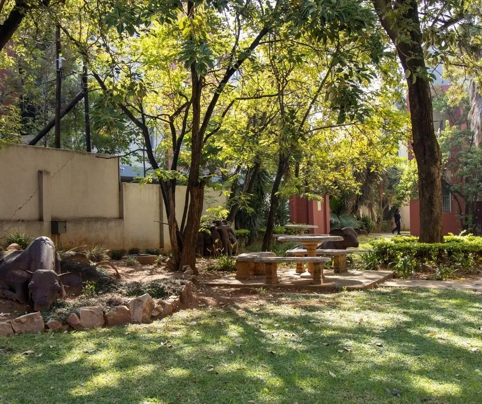 A shaded garden with benches at a residence